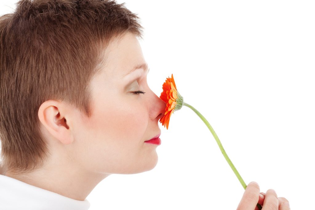 Woman smelling orange flower