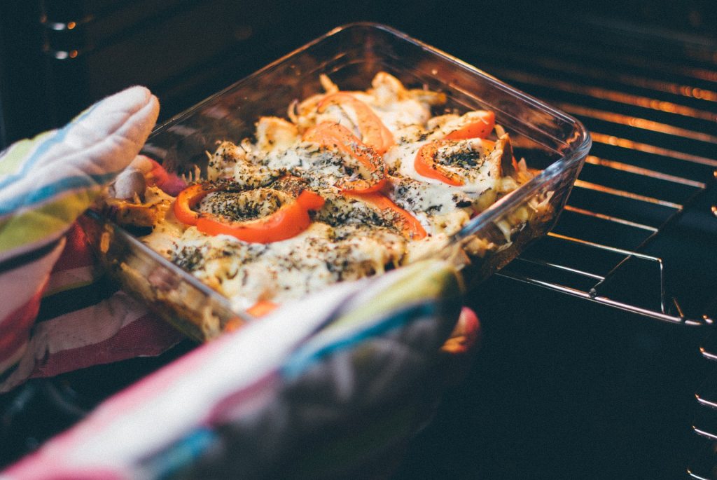 Casserole dish being put into oven