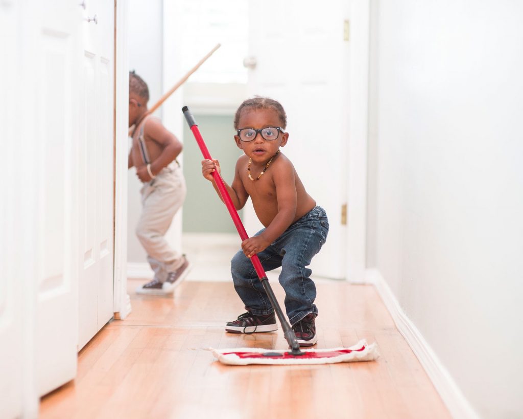 Young boy playing with mop