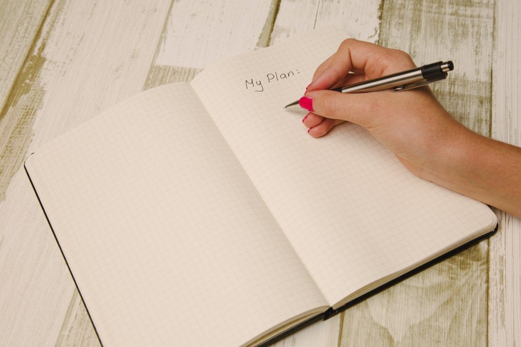 Hand writing a plan in diary