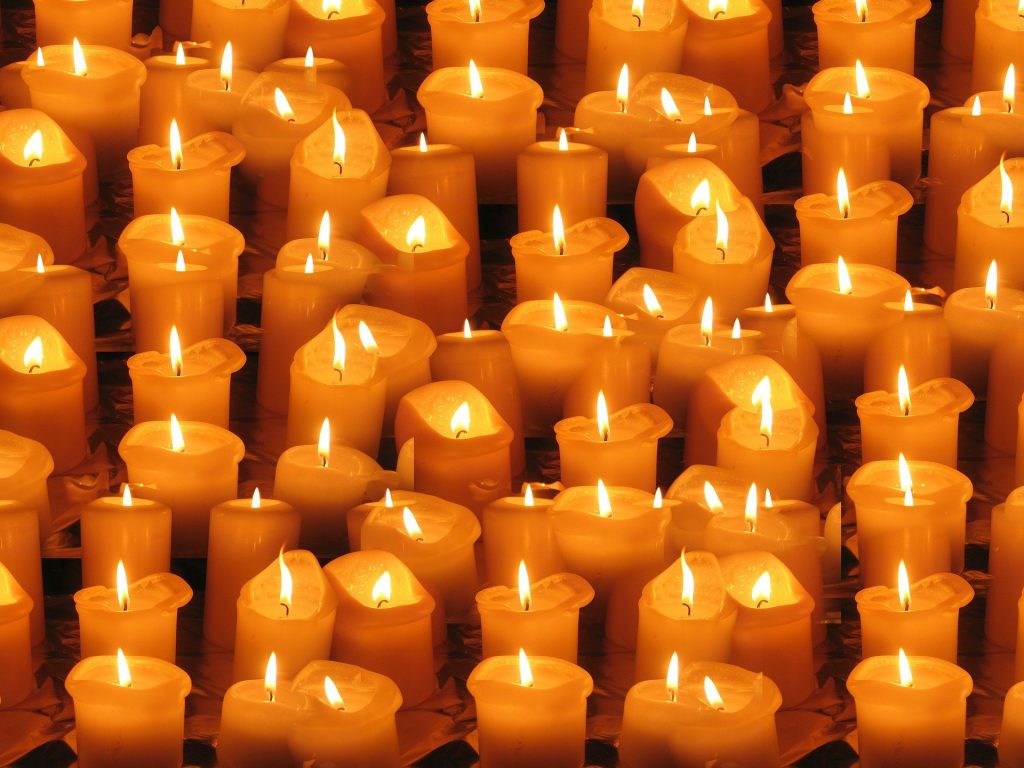 Collection of lit wax candles