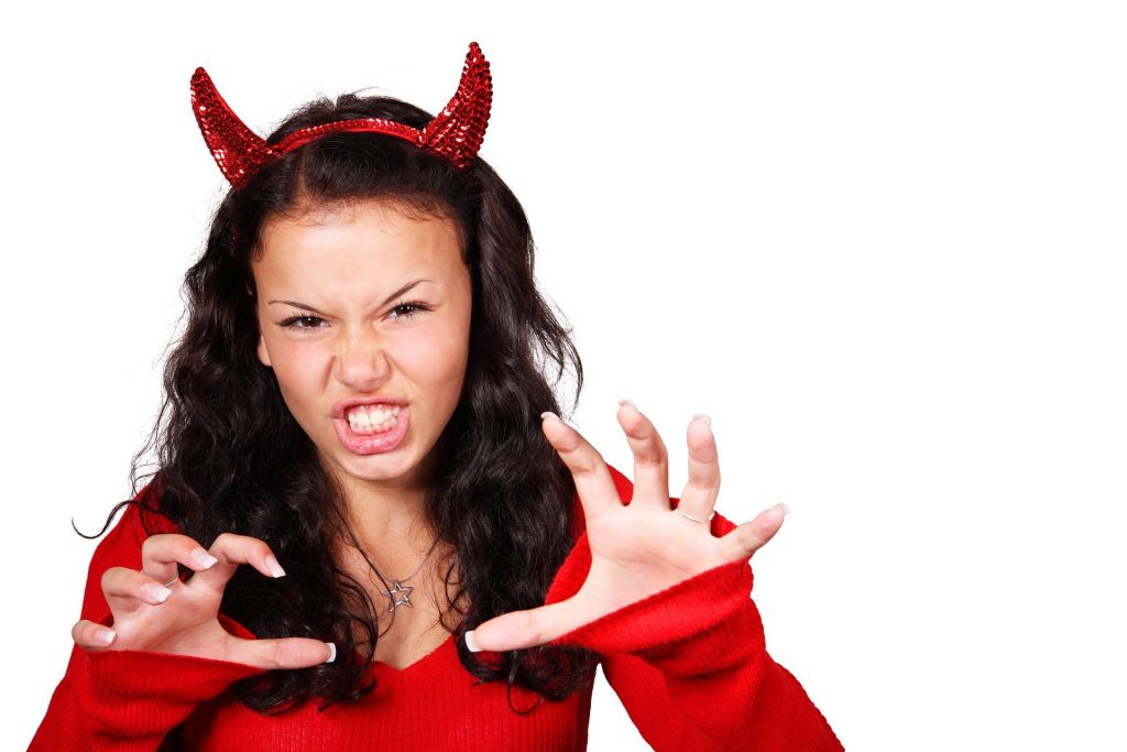 Woman in devil outfit growling like a tiger