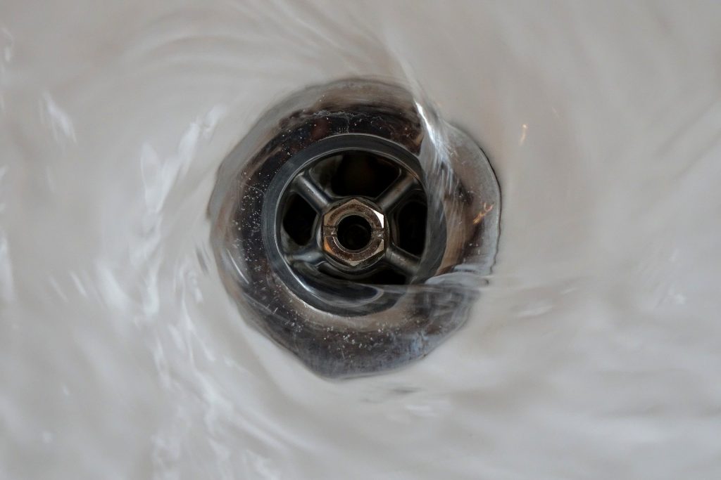 Water flowing down plughole