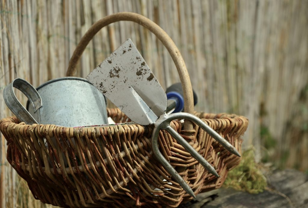 Wicker basket of garden tools