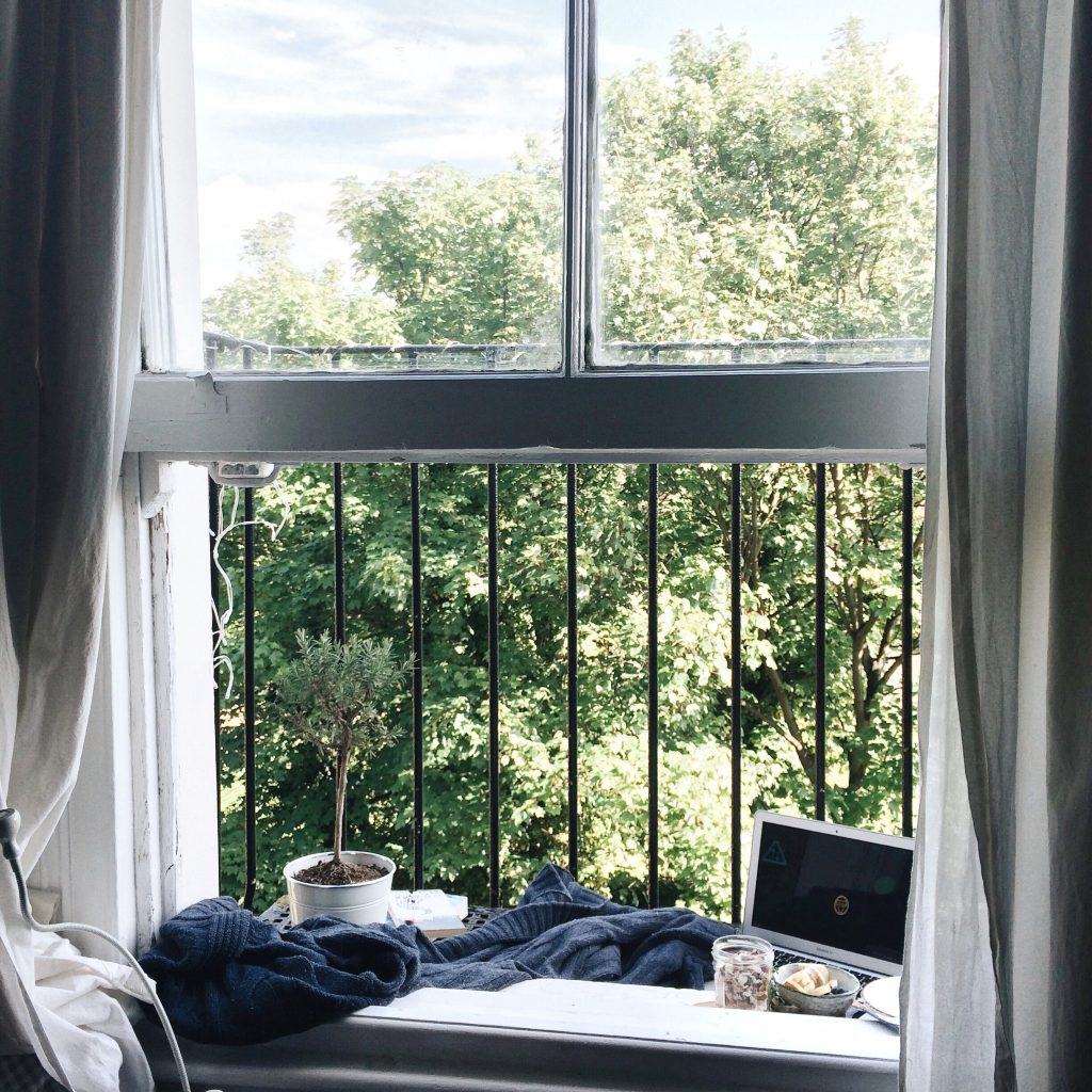 Open window onto small balcony in the sun