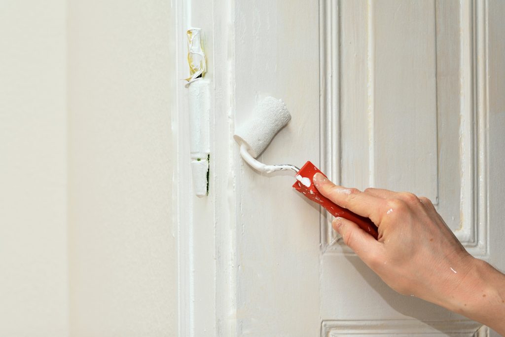 Hand painting white door with roller