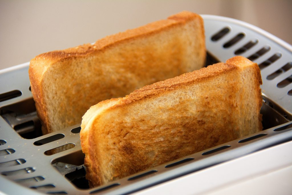 Two slices of toast in toaster