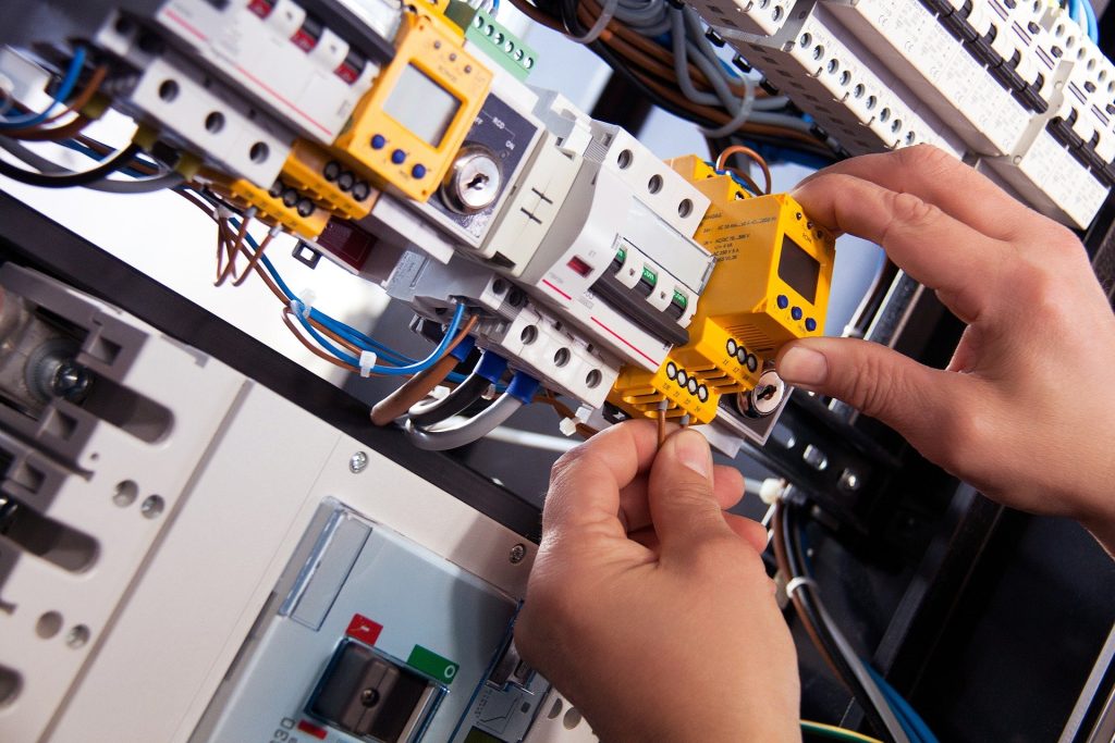 Hands working on electrical wiring