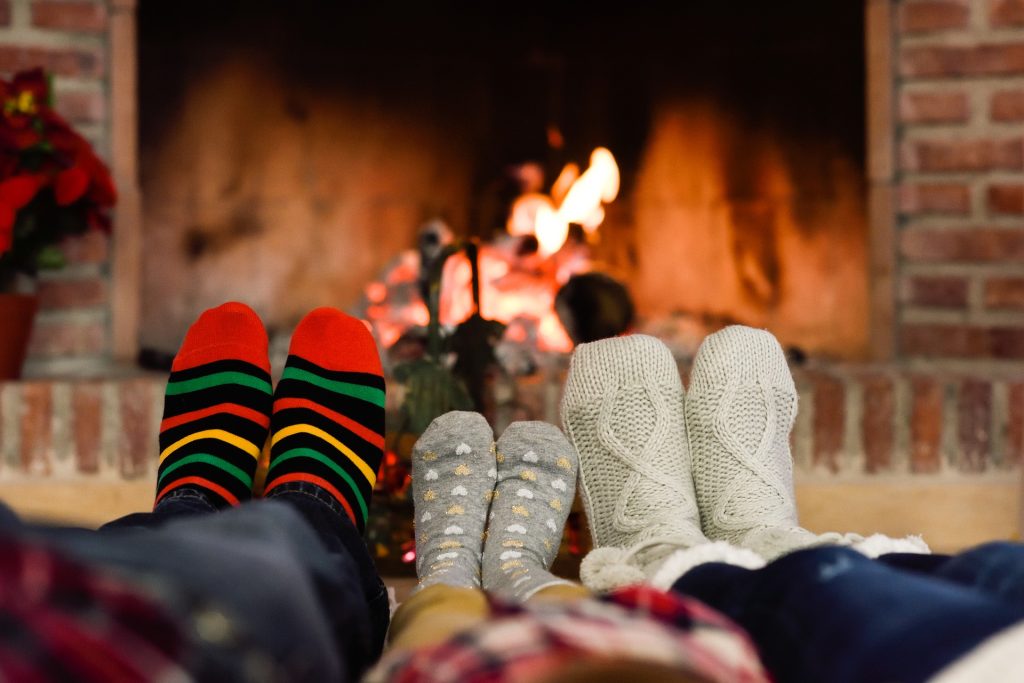 Feet in socks in front of fireplace