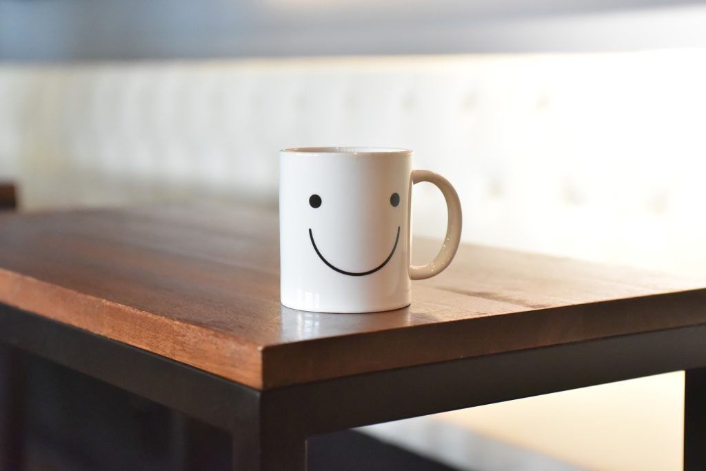 Smiley face mug on coffee table