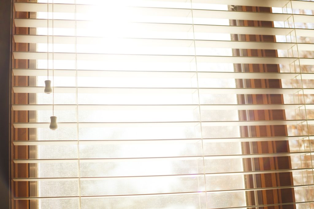 Sun coming through blinds at window