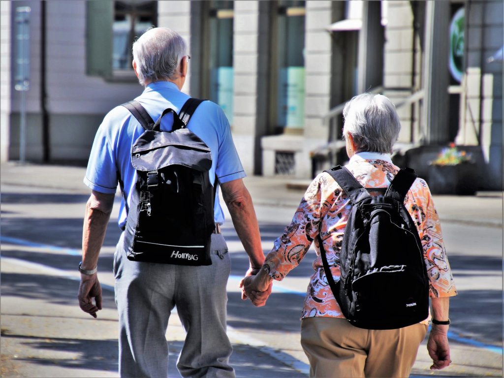 Elderly couple holding hands