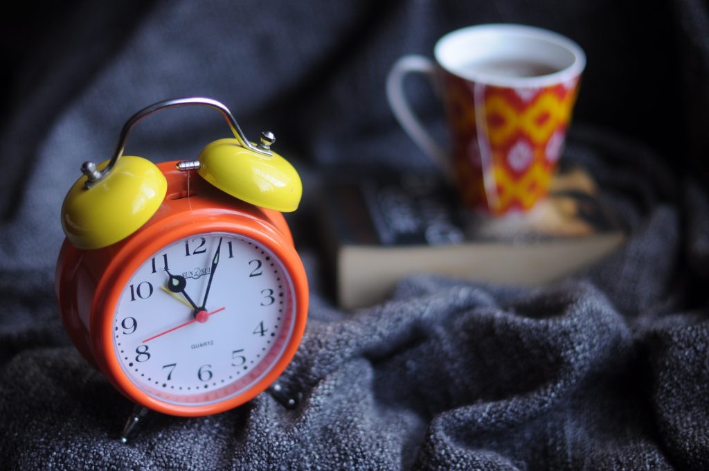 Alarm clock and mug of tea
