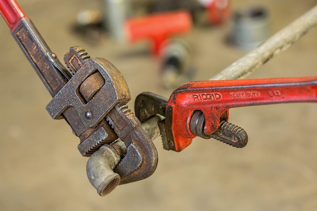 Wrenches working on pipe